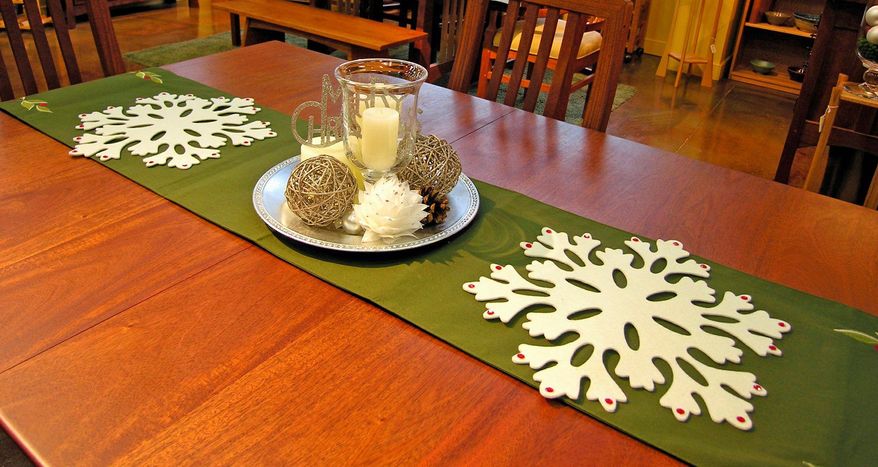 Photo courtesy of Denise Willard
Using a decorative charger as a platter to hold a "candlescape" and finishing off the table runner with some snowflakes can perk up a holiday table.