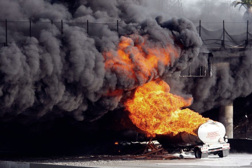 A burning double-tanker gasoline truck halted and rerouted traffic Wednesday in Montebello, Calif. Thousands of motorists were stuck in place when a 10-mile stretch of freeway near Los Angeles was closed because of the fire. (Associated Press)