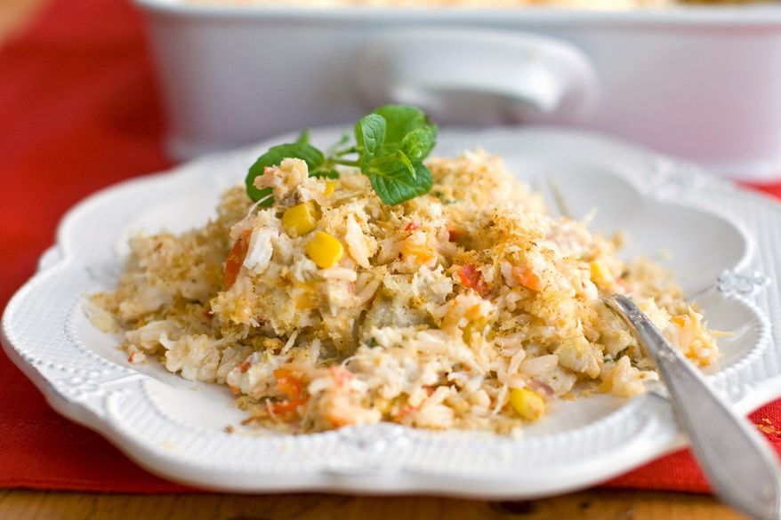 This easy, portable casserole takes the flavors of a creamy crab dip and turns it into a meal for 16 - or even more for a potluck dinner. (Associated Press)