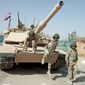 ON THEIR OWN: Iraqi army soldiers train with an M1 Abrams tank, purchased from the U.S., during an exercise in Baghdad.