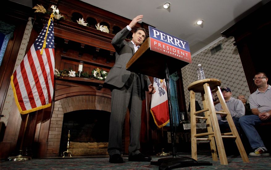 Texas Gov. Rick Perry speaks at Bayliss Park Hall in Council Bluffs, Iowa, during a campaign stop Wednesday. All of the GOP candidates were in Sioux City for the final scheduled debate of the year Thursday night. (Associated Press)