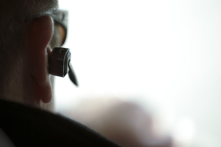 Dan Johnson uses a hands-free device to talk on a cellphone Dec. 14, 2011, while driving in San Diego. Johnson, an operations manager, uses his cellphone while driving frequently for business. (Associated Press)