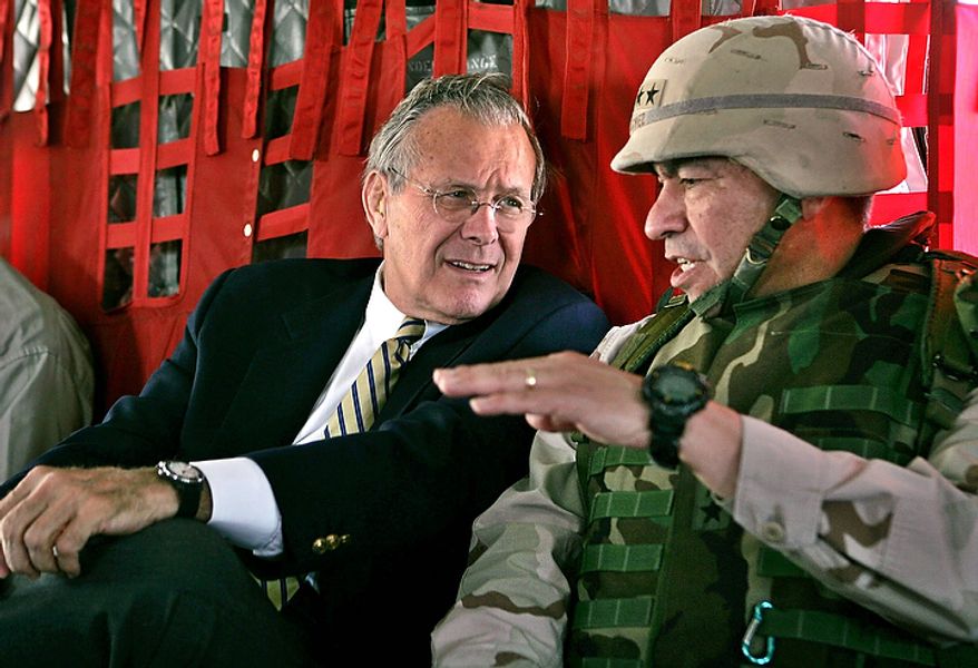 In this May 13, 2004, file photo, Secretary of Defense Donald Rumsfeld, left, listens to Gen. Ricardo Sanchez, Commander of the coalition forces in Iraq, during his flight from Kuwait City to Baghdad. In the beginning, it all looked simple: topple Saddam Hussein, destroy his purported weapons of mass destruction and lay the foundation for a pro-Western government in the heart of the Arab world. Nearly 4,500 American and more than 100,000 Iraqi lives later, the objective now is simply to get out _ and leave behind a country where democracy has at least a chance, where Iran does not dominate and where conditions may not be good but "good enough." (AP Photo/David Hume Kennerly, Pool, File)