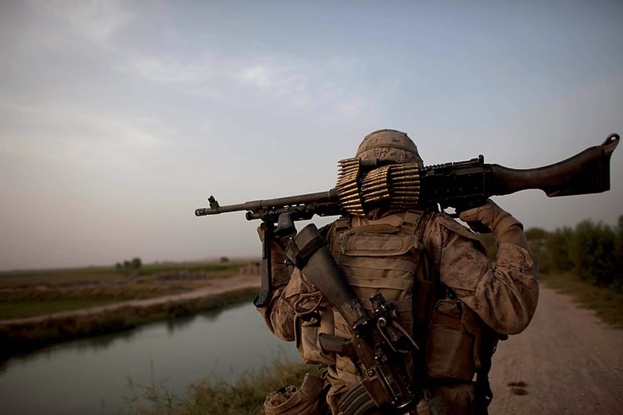 In this Aug. 25, 2011, file photo U.S. Marine Lance Cpl. Lane Edward Morrow,of Susanville, Calif., of the 3rd Platoon, Kilo Company, 3/4 Marines, guards a vehicle checkpoint in early morning in Helmand province, southern Afghanistan. "We need to get back to our bread and butter" Marine Corps commandant, Gen. James F. Amos, told Marines Nov. 23 at Camp Lawton, a U.S. special operations base in Afghanistan's Herat province. That begins, he said, with moves such as returning to a pattern of continuous rotations of Marines to the Japanese island of Okinawa, home of the 3rd Marine Division formed in the early days of World War II. (AP Photo/Brennan Linsley, File)