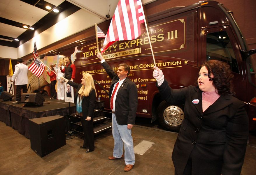 Amy Kremer (right) and Mark Williams (second from right) wave flags during the Tea Party Express rally at the state Republican convention in Santa Clara, Calif., on Saturday, March 13, 2010. (AP Photo/Tony Avelar)