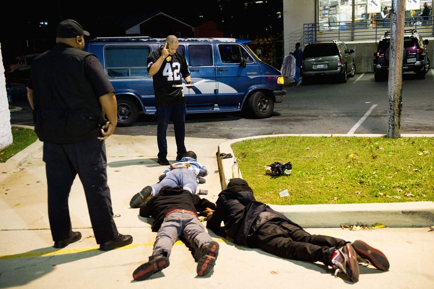Teenagers were caught drinking by undercover security outside Plaza 23 Event Center in Temple Hills in mid-October. (Andrew Harnik/The Washington Times)