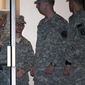 Army Pfc. Bradley Manning (second from left) is escorted from a courthouse in handcuffs on Saturday, Dec. 17, 2011, at Fort Meade, Md. (AP Photo/Cliff Owen)