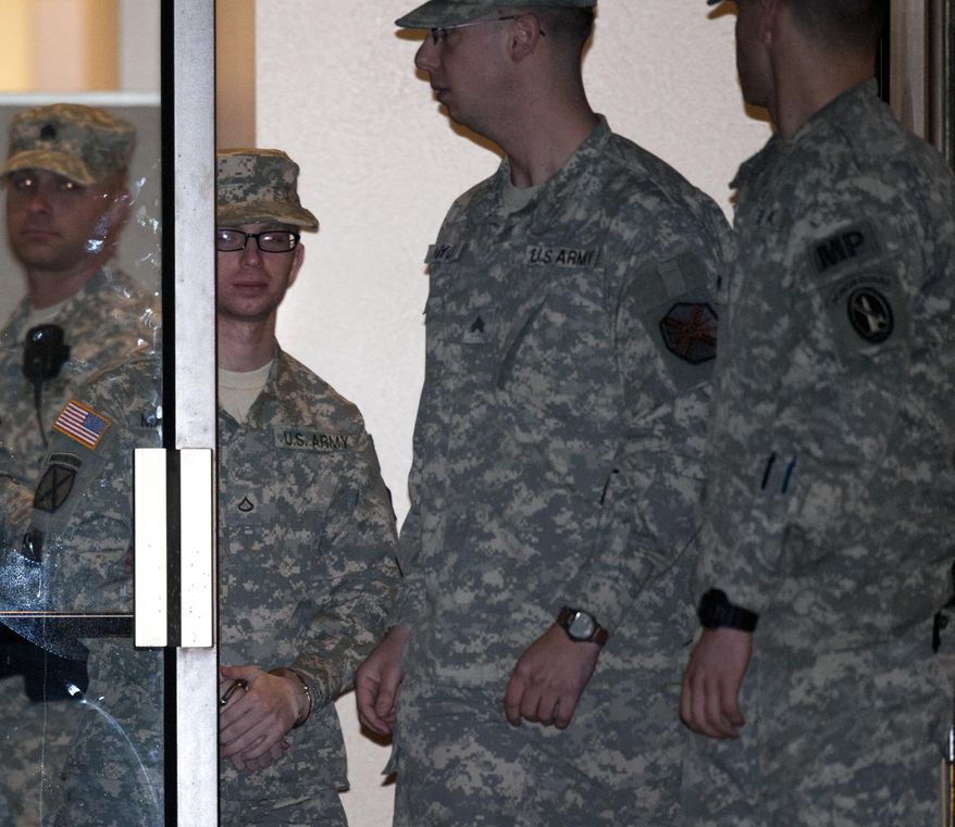 Army Pfc. Bradley Manning (second from left) is escorted from a courthouse in handcuffs on Saturday, Dec. 17, 2011, at Fort Meade, Md. (AP Photo/Cliff Owen)