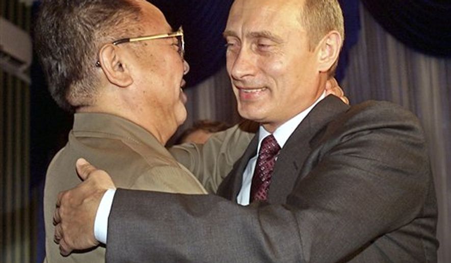 Russian President Vladimir Putin (right) greets North Korean leader Kim Jong-il during their meeting in Vladivostok, Russia, on Aug. 23, 2002. (AP Photo/Alexander Zemlianichenko, File)