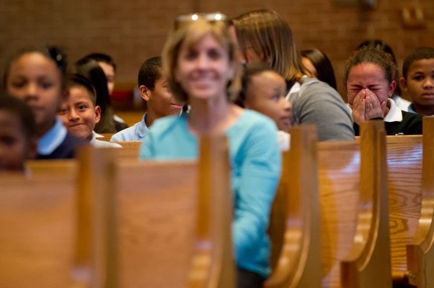 Air Force Brigadier General Select Peter Masciola surprises his 12 year old daughter Tamara, right, at Saint Columbus School in Oxon Hill, Maryland. (Andrew Harnik / The Washington Times)