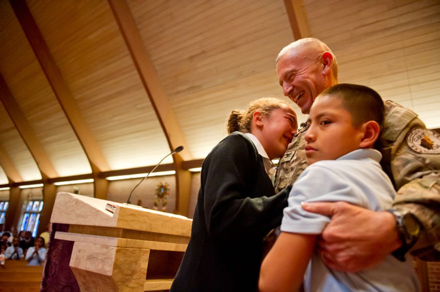 Air Force Brigadier General Select Peter Masciola surprises his 10 year old son Kevin and 12 year old daughter Tamara at their school. (Andrew Harnik / The Washington Times)