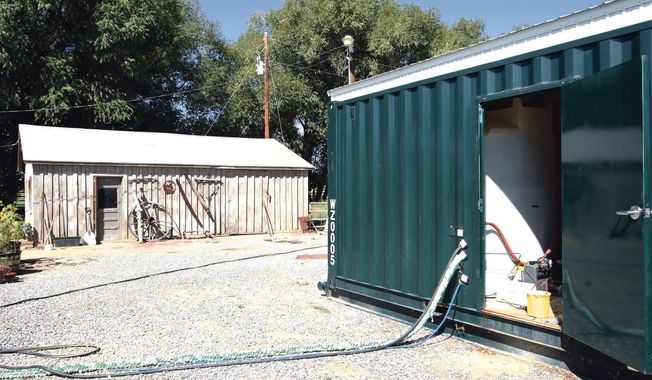 ** FILE ** In this Sept. 14, 2009 photo, Encana Corp. placed two 2400 gallon water containers inside this unit on Louis Meeks&#x27; property in Pavillion, Wyo. The ranking Republican on the Senate Environment and Public Works Committee — Oklahoma Sen. James Inhofe — is asking the head of the U.S. Environmental Protection Agency for more information about an EPA investigation into groundwater contamination in a Wyoming gas field. (AP Photo/Casper Star-Tribune, Kerry Huller)