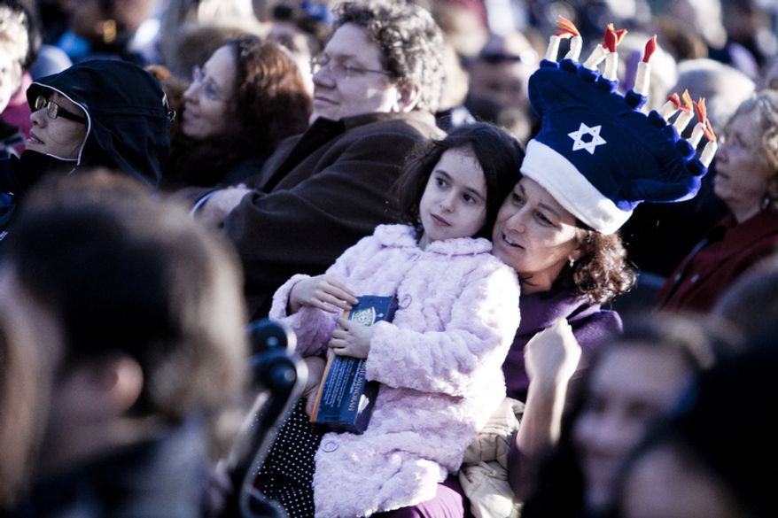 Irene Gal-Edd, of Bethesda, Md., holds her daughter Pearly, 7, during the National Chanukah Menorah Lighting on the Ellipse in Washington, D.C. on Dec. 20, 2011.
(T.J. Kirkpatrick/ The Washington Times)