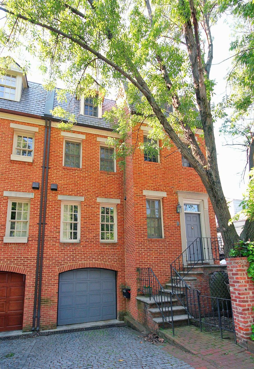 The home at 3242 Reservoir Road NW is on the market for $1,645,000. The Federal-style town home has a one-car garage, four finished levels and an elevator that serves all four floors.