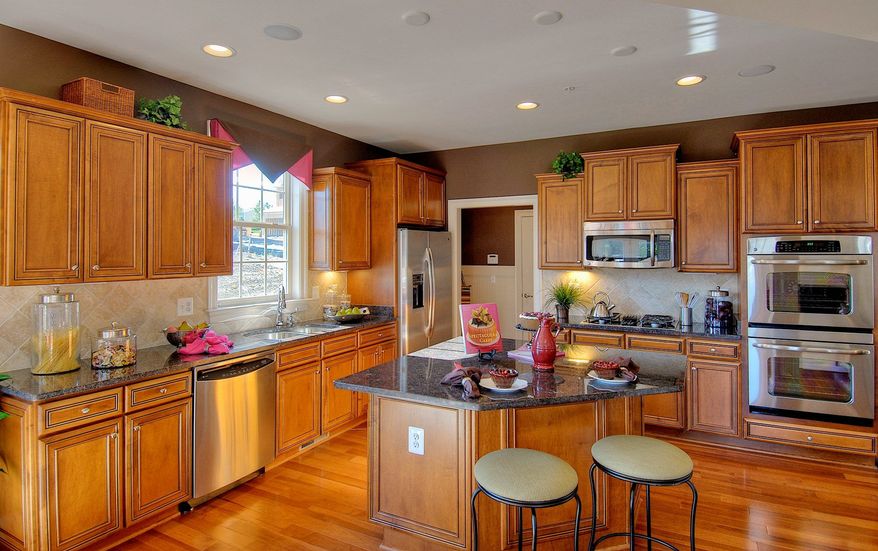 The Easton model at Kensington Heights includes a center-island kitchen open to both a breakfast area and the family room. The main level also has a library, a formal living room and a formal dining room.
