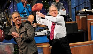 In this photo released by CBS, host David Letterman, right, and comic Jay Thomas get ready to throw footballs at the Late Show Christmas tree during the annual Late Show Holiday Quarterback Challenge on the set of &quot;Late Show with David Letterman,&quot; airing Thursday, Dec. 23, 2011 on the CBS Television Network. Thomas and Letterman each take turns tossing footballs at the Late Show Christmas tree to try and knock off the giant meatball perched at its top. (AP Photo/CBS, John Paul Filo)