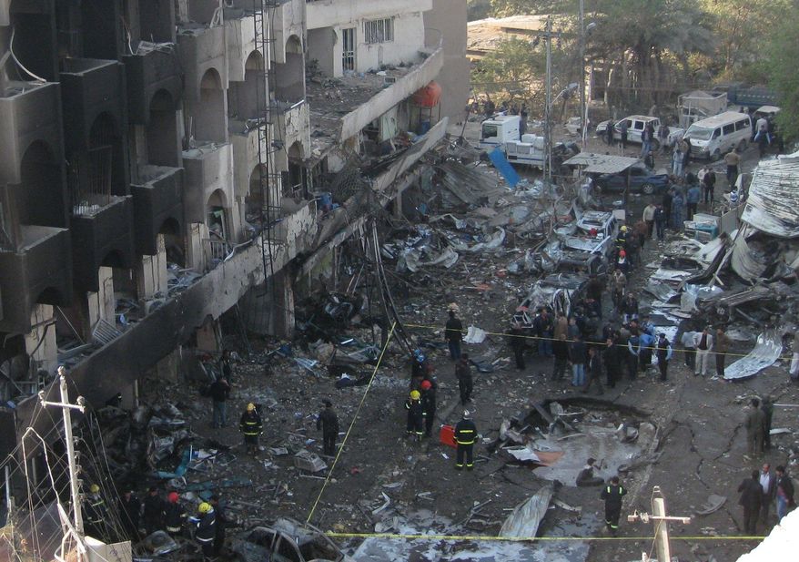 Iraqi security forces inspect a crater created by a car-bomb attack in the neighborhood of Karrada in Baghdad. A series of blasts Thursday morning killed or wounded scores of people in coordinated explosions designed to wreak havoc in the capital. The last U.S. combat troops left the country on Sunday. (Associated Press)