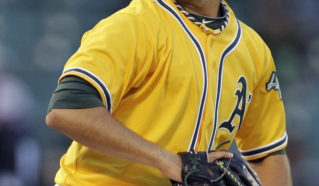 FILE - In this April 14, 2011, file photo, Oakland Athletics' Gio Gonzalez pitches against the Detroit Tigers during a game in Oakland, Calif. The Washington Nationals acquired the left-hander (pending physicals) for four prospects Thursday evening. (AP Photo/Ben Margot, File)