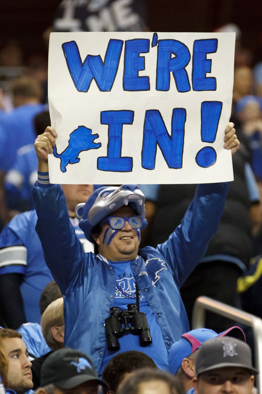 A fan holds a sign for the Detroit Lions making the playoffs in a game against the San Diego Chargers in Detroit, Saturday, Dec. 24, 2011. Detroit won 38-10 to clinch a playoff spot. (AP Photo/Rick Osentoski)