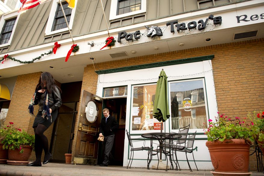Customers exit Pat Troy's Ireland's Own restaurant and pub, a local landmark for 31 years in Alexandria. The owner has written a book about his experiences and the famous people he's met, including President Reagan and aviator Charles A. Lindbergh. Mr. Troy also hosts "Pat Troy's Irish Radio Show" on Sunday mornings. (Rod Lamkey Jr./The Washington Times)