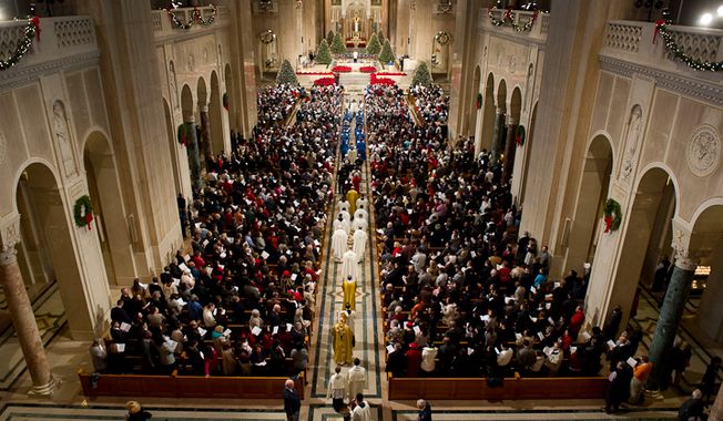 Archbishop of Washington Cardinal Donald Wuerl makes his way down the center isle at the beginning of Christmas Mass held at the Basilica of the National Shrine of the Immaculate Conception on Christmas Day, Washington, D.C., Sunday, Dec. 25, 2011. (Andrew Harnik/The Washington Times)