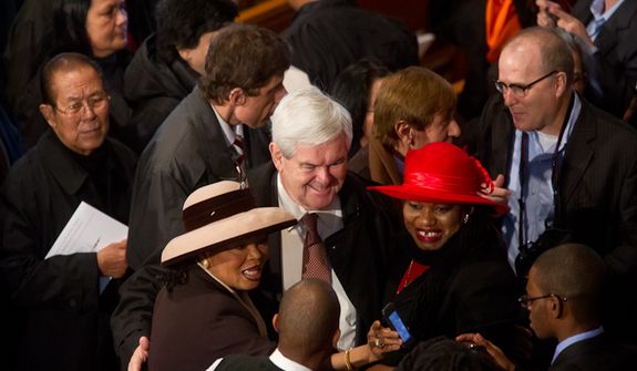 Former Speaker of the House and current Republican presidential candidate Newt Gingrich poses for photos with fellow worshippers following Christmas Mass at the Basilica of the National Shrine of the Immaculate Conception on Christmas Day, Washington, D.C., Sunday, Dec. 25, 2011. (Andrew Harnik/The Washington Times)