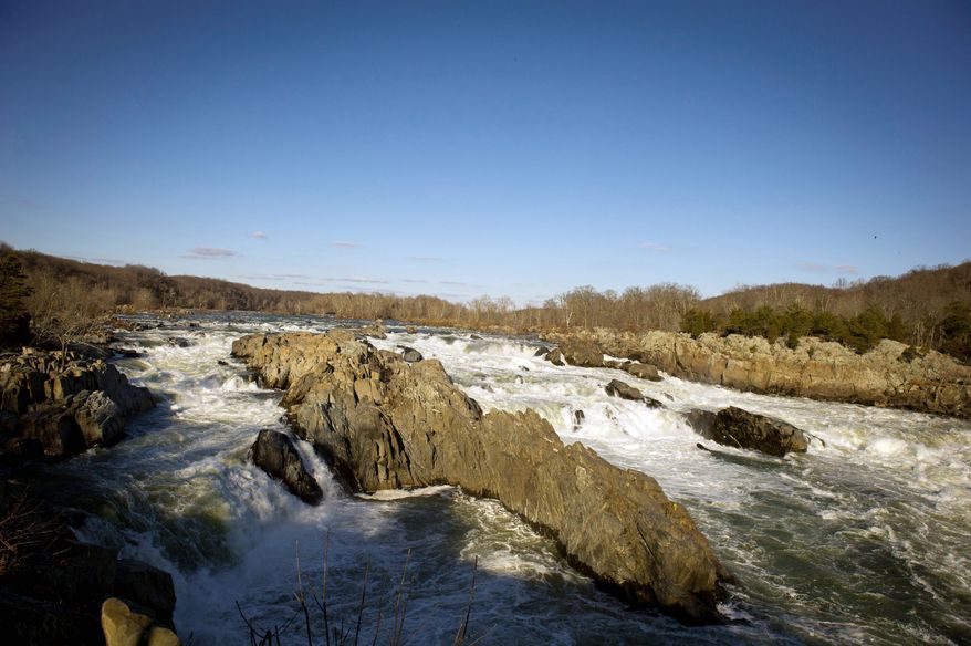 Backed by the late afternoon sun, the Potomac River rolls over the rocks at Great Falls. (Rod Lamkey Jr./The Washington Times)