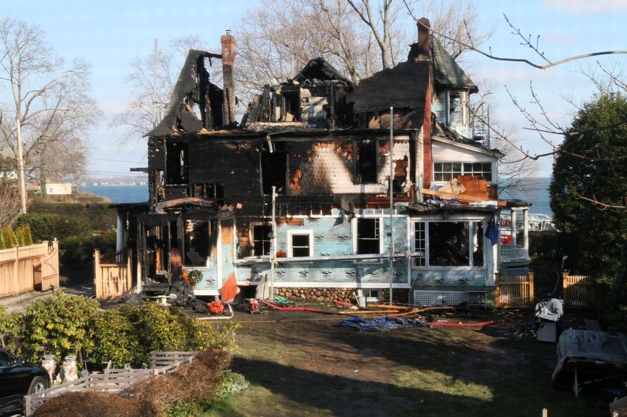 Fire destroyed a Victorian-style house on Long Island Sound in Stamford, Conn., on Sunday, Dec. 25, 2011. Officials said two adults and three children died in the blaze, and two others escaped. (AP Photo/Tina Fineberg)