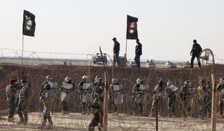 **FILE** Iraqi police stand guard outside Camp Ashraf, northeast of Baghdad, in December 2011. (Associated Press/People&#39;s Mujahedeen Organization of Iran)