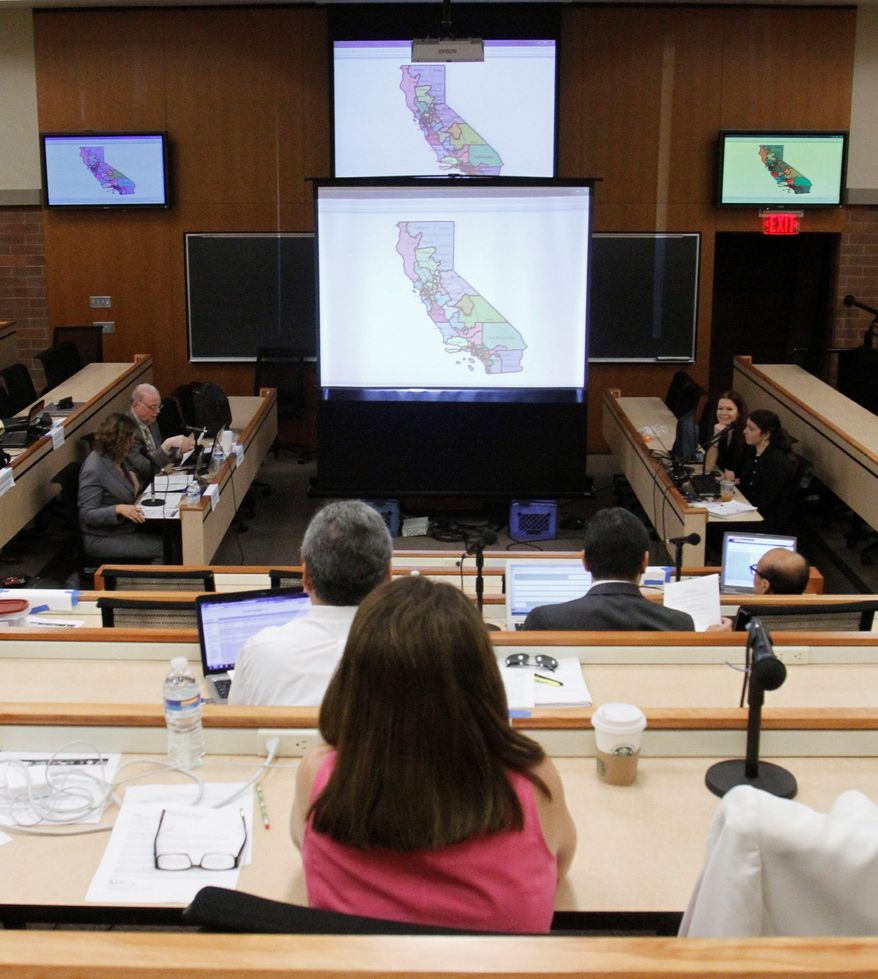 Members of the California Citizens Redistricting Commission study a district map under consideration during a hearing held in Sacramento in July. The commission produced a vastly different congressional map from what state lawmakers drew up in 2001, which essentially preserved nearly every incumbent district and deleted just one Republican district. (Associated Press)