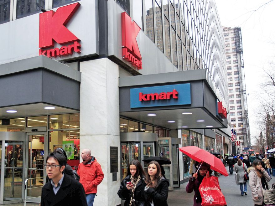 Pedestrians pass a Kmart store on Tuesday, Dec. 27, 2011, in New York. (AP Photo/Frank Franklin II)