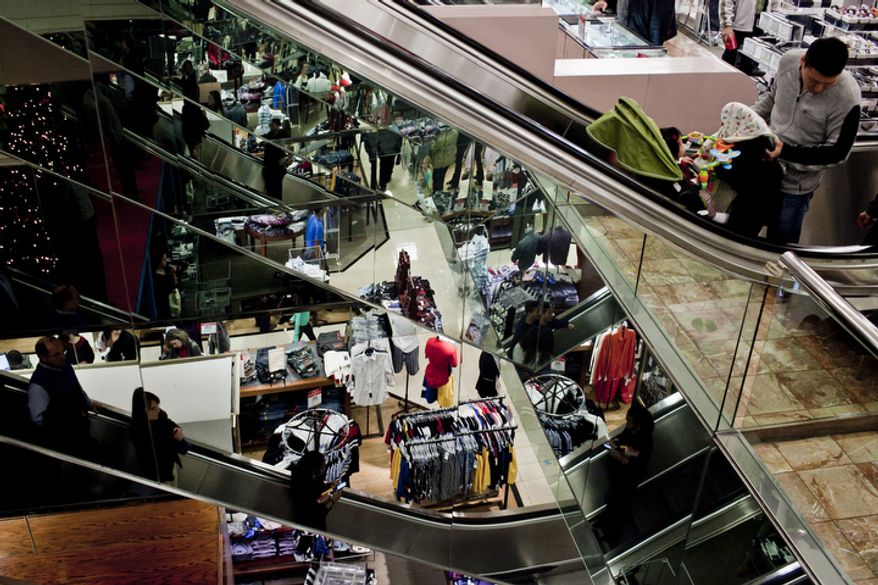Shoppers file through Macy's at the Tysons Corner Center mall in McLean, Va., for returns and after-Christmas sales on Dec. 26, 2011. (T.J. Kirkpatrick/ The Washington Times)