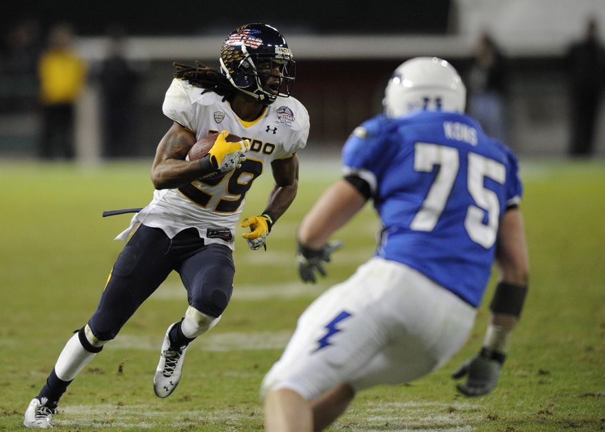 Toledo safety Jermaine Robinson, left, runs with the ball after he intercepted a pass, as Air Force offensive linesman Jason Kons (75) pursues during the second half of the Military Bowl college football game, Wednesday, Dec. 28, 2011, in Washington. Robinson scored a touchdown on the play as Toledo won 42-41. (AP Photo/Nick Wass)