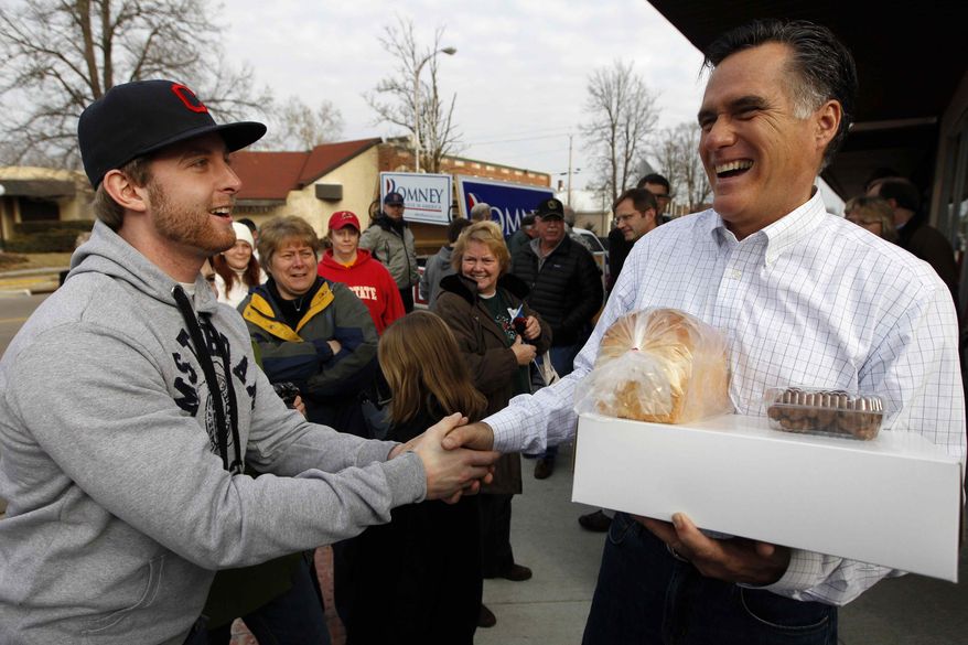 Republican presidential candidate, former Massachusetts Gov. Mitt Romney greets supporters after a campaign stop at Homer&#39;s Deli and Bakery in Clinton, Iowa, Wednesday, Dec. 28, 2011. (AP Photo/Chris Carlson)