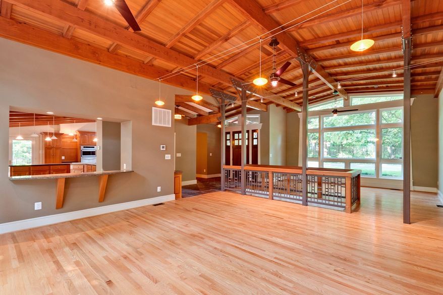 A distinctive staircase with wood- and wrought-iron railings separates the living room from the family room. A large pass-through connects the family room and the kitchen.