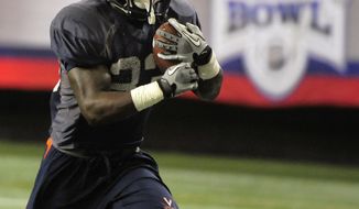 Virginia tailback Perry Jones runs during practice for the Chick-fil-A Bowl at the Georgia Dome on Tuesday, Dec. 27, 2011, in Atlanta. (AP Photo/David Tulis)