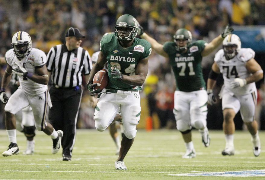 Baylor's Terrance Ganaway (center) rushes for a touchdown during the second half of Baylor's 67-56 victory over Washington in the Alamo Bowl at the Alamodome in San Antonio on Dec. 29, 2011. (Associated Press)