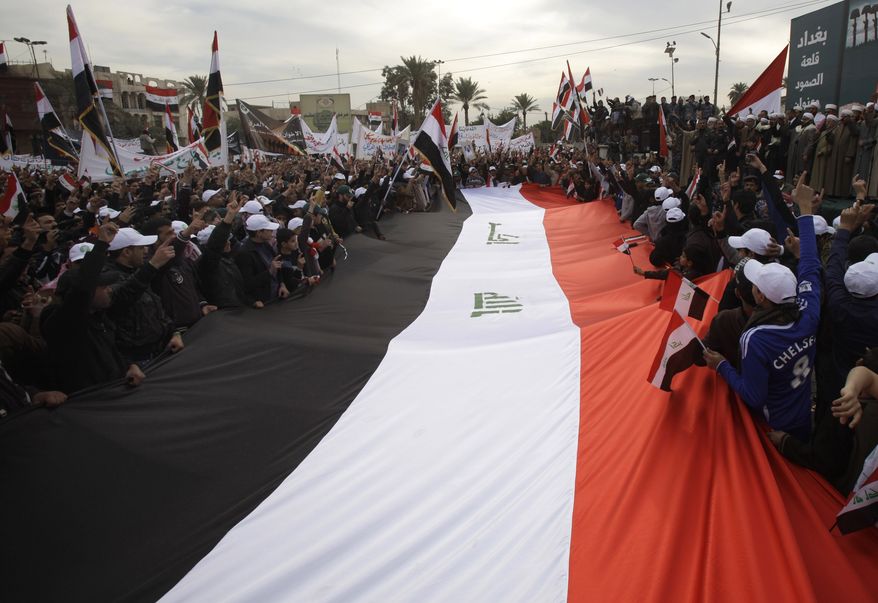 Protesters chant anti-U.S. slogans and wave Iraqi flags Dec. 30, 2011, during a demonstration in the Azamiyah neighborhood of Baghdad. Hundreds of Iraqi Sunnis have celebrated the departure of the American forces from Iraq, amid sectarian tensions. (Associated Press)