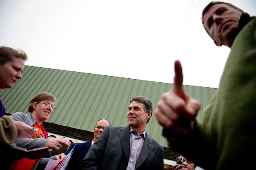 Republican presidential candidate Rick Perry speaks with supporters in the parking lot outside the Fainting Goat Restaurant where he spoke to a full room, Waverly, IA, Friday, December 30, 2011. (Andrew Harnik / The Washington Times)