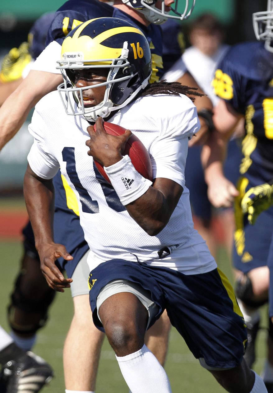 Michigan quarterback Denard Robinson (16) runs during practice in New Orleans, Friday, Dec. 30, 2011, for the upcoming BCS Sugar Bowl scheduled for Jan. 2 against Virginia Tech. (AP Photo/Gerald Herbert)