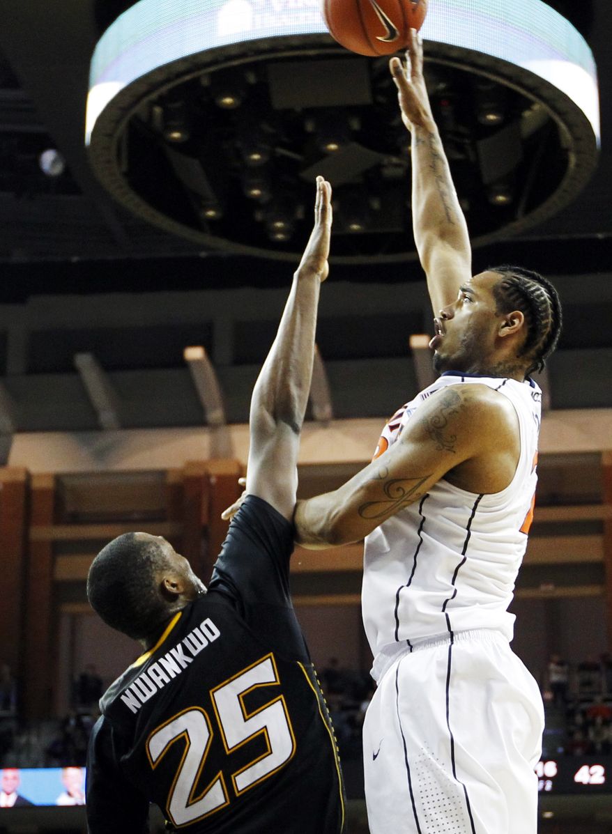 Virginia forward Mike Scott (23) shoots over Towson forward Robert Nwankwo (25) during a game, Friday, Dec. 30, 2011, in Charlottesville, Va. Virginia won 57-50, though Scott was limited to just seven points. (AP Photo/The Daily Progress, Sabrina Schaeffer)