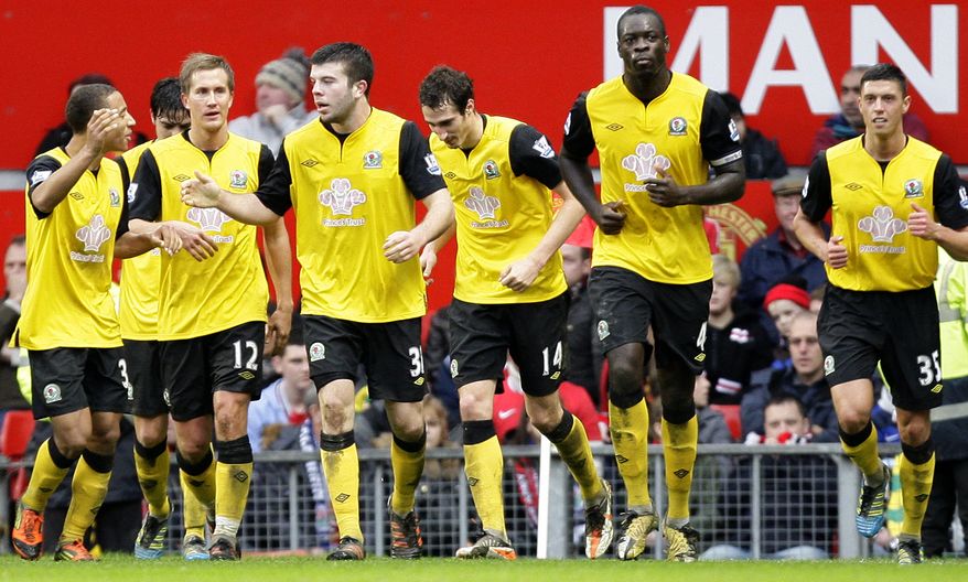 Blackburn Rovers' Grant Hanley, third left, is congratulated by teammates after scoring the winning goal during the English Premier League soccer match against Manchester United at Old Trafford Stadium, Manchester, England, Saturday Dec. 31, 2011. Blackburn won 3-2. (AP Photo/Jon Super)