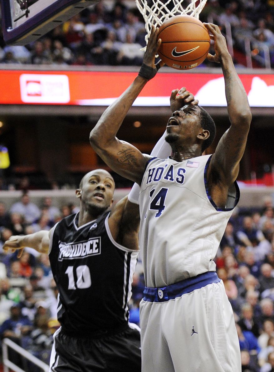 Georgetown center Henry Sims, right, goes to the basket against Providence forward Kadeem Batts (10) during the second half, Saturday, Dec. 31, 2011, in Washington. Georgetown won 49-40. (AP Photo/Nick Wass)