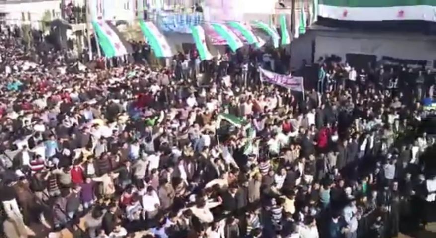 In this image from amateur video made available by the Ugarit News group and shot on Friday, Dec. 30, 2011, protesters gather at an anti-Bashar Assad rally in Hama, Syria. The Associated Press cannot independently verify the content, date, location or authenticity of this material. (AP Photo/Ugarit News Group via APTN)