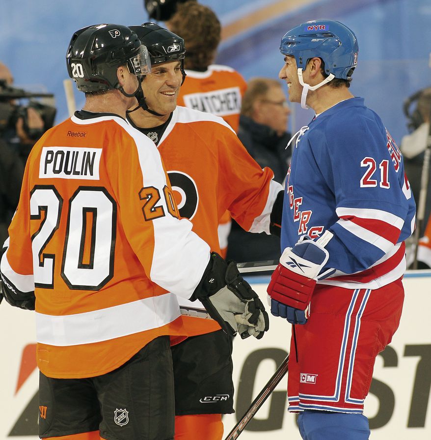 Dave Poulin, left, and Rick Tocchet, center, of the Philadelphia Flyers alumni team, talk with Mathieu Schnieder, right, of the New York Rangers alumni team, during the second period of the Winter Classic Alumni NHL hockey game on Saturday, Dec. 31, 2011, in Philadelphia. (AP Photo/Tom Mihalek)