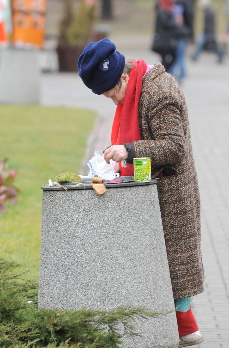 A woman sifts through garbage in Warsaw. Many Poles and citizens of other Eastern and Central European nations argue that they should not have to sacrifice to help people in the West, who enjoy a much higher standard of living even though their states are crushed by mountains of debt.