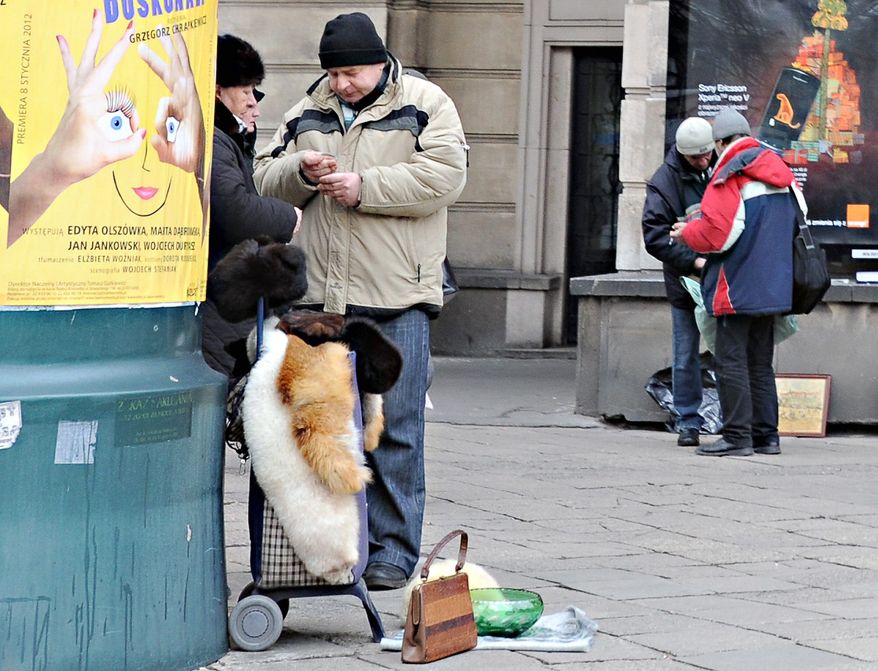 Poles sell used items on a street in Warsaw in mid-December. Poland still faces many economic problems despite strong growth since joining the European Union in 2004. People across Central and Eastern Europe are balking at requests that they help bailout the eurozone. (Associated Press)