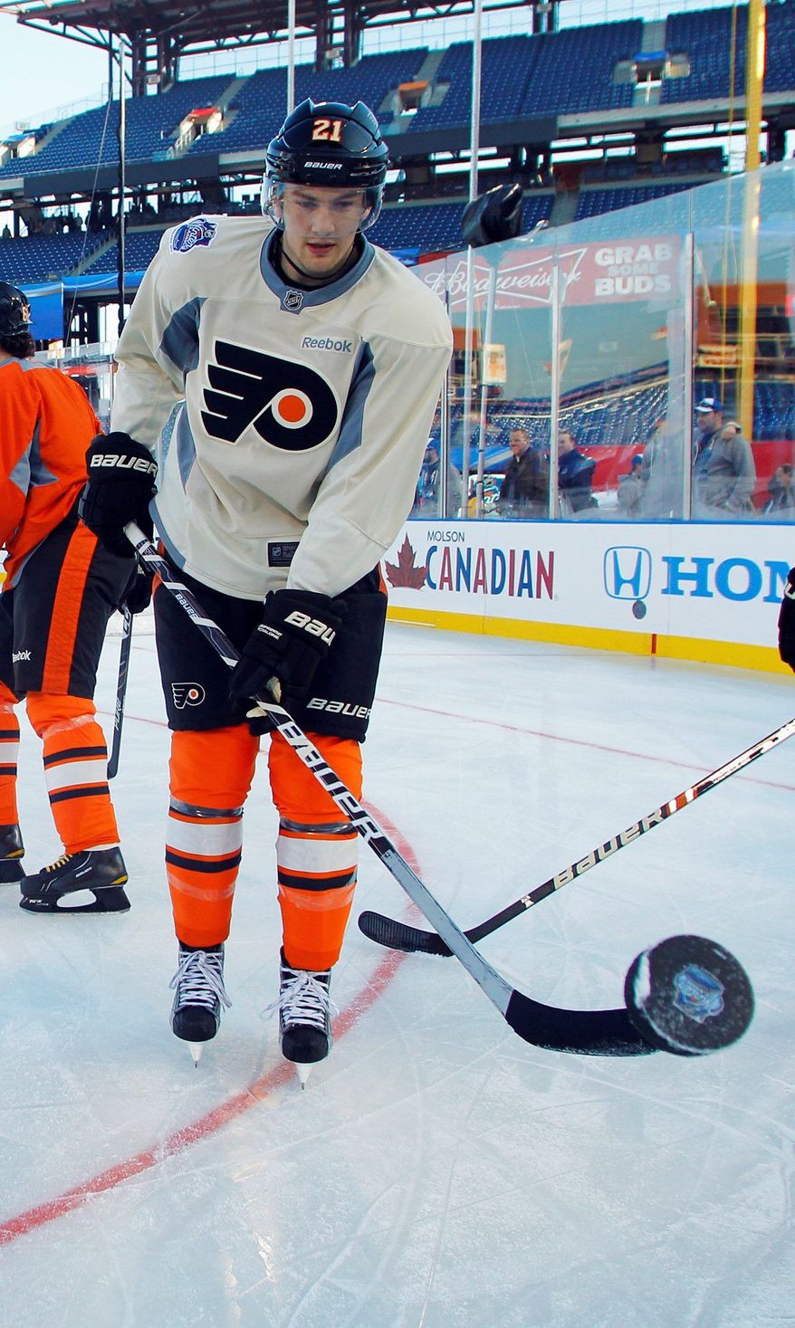Philadelphia Flyers forward James van Riemsdyk lofts the puck with his stick during practice for the Winter Classic. The 22-year-old Van Riemsdyk has nine goals and 19 assists in 31 games. (Associated Press)
