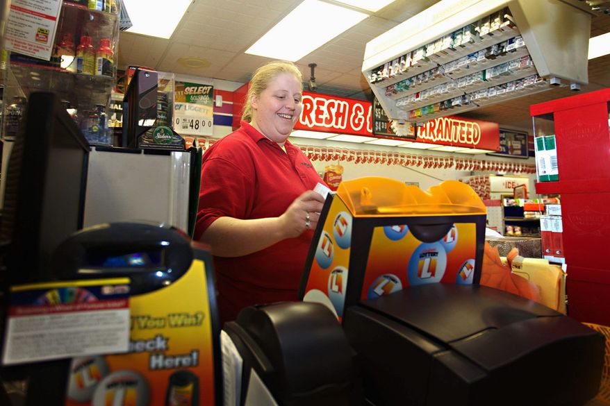 Amber Wallenstein, a clerk at the Freedom Value Center convenience store and gas station in Sioux Falls, S.D., rings up a Powerball ticket for a customer. The price for the multistate Powerball tickets is set to double Jan. 15. "I don't think anybody knows about it yet," Ms. Wallenstein said of the price hike. "But they'll still pay for it." (Associated Press)
