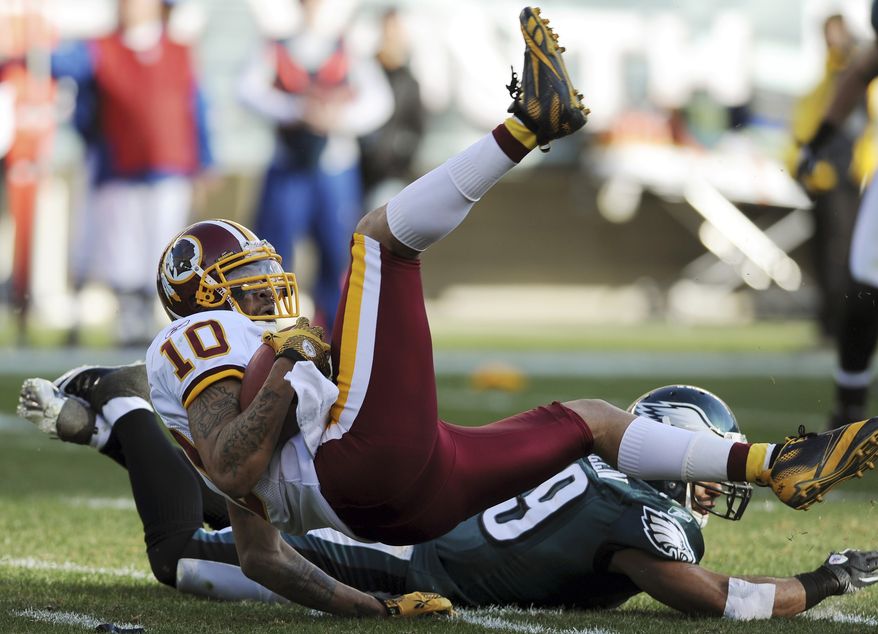Jabar Gaffney (10) of the Washington Redskins lands after a tackle by the Philadelphia Eagles' Nate Allen (29) during the first half of an NFL game on Sunday, Jan. 1, 2012, in Philadelphia. (AP Photo/Michael Perez)